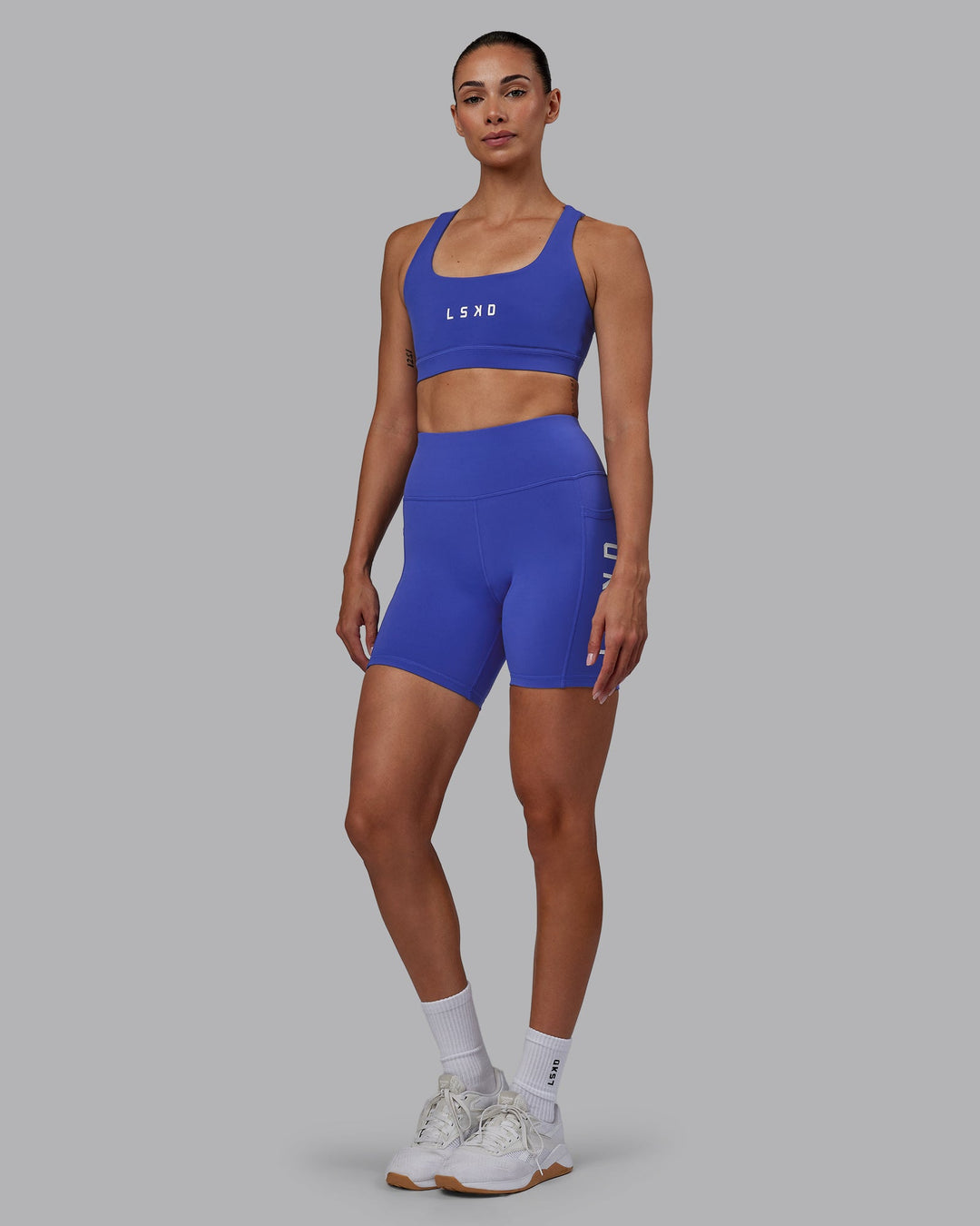 Woman wearing Rep Mid-Length Shorts - Power Cobalt-White