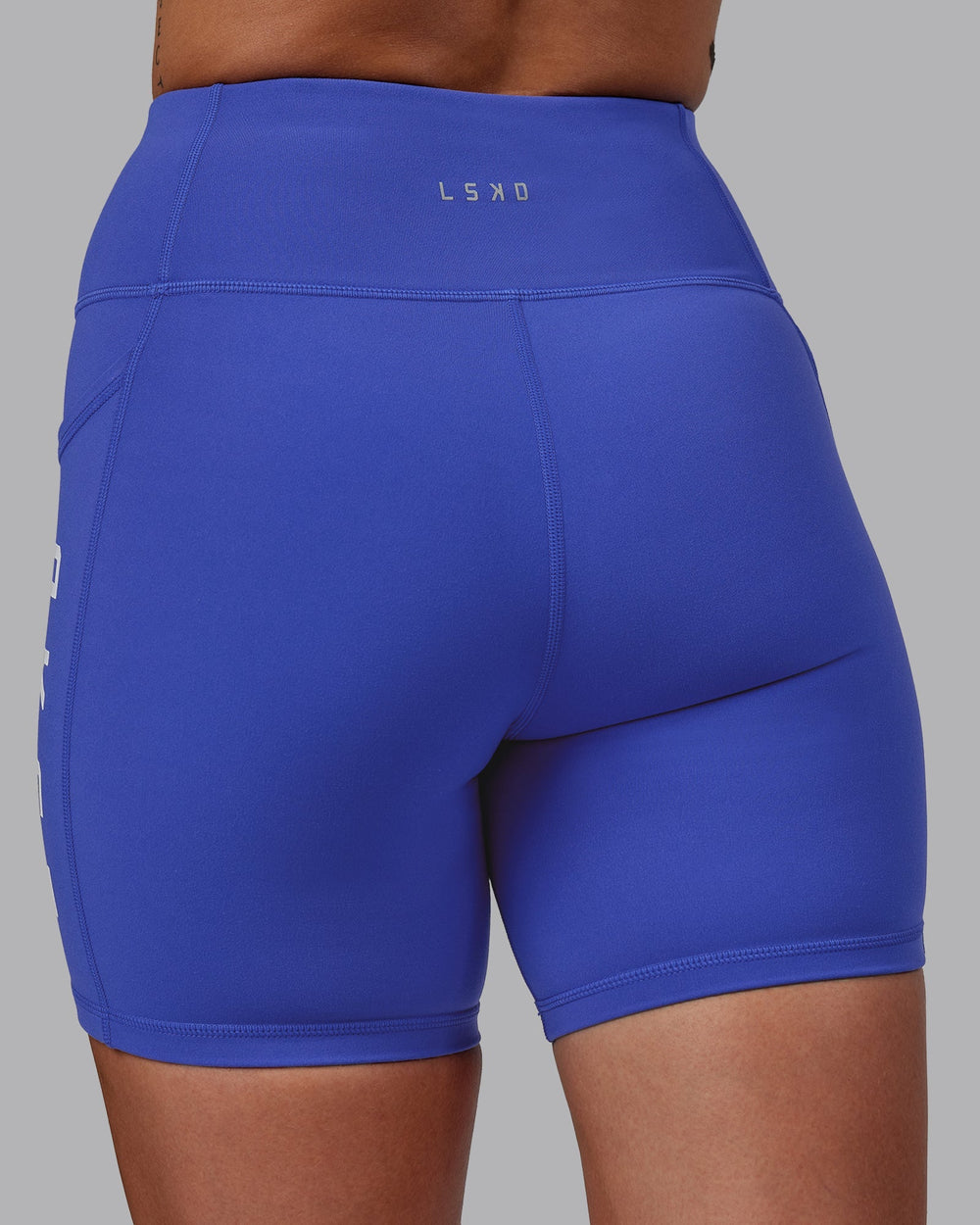 Woman wearing Rep Mid-Length Shorts - Power Cobalt-White