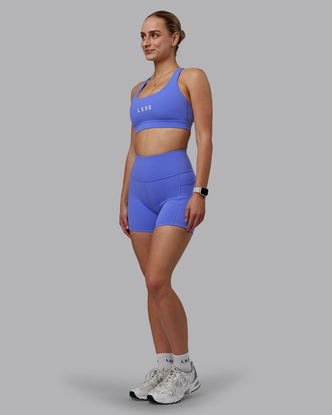 Woman wearing Rep Sports Bra - Baja Blue-White