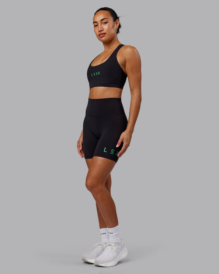 Woman wearing Rep Sports Bra - Black-Impact Green
