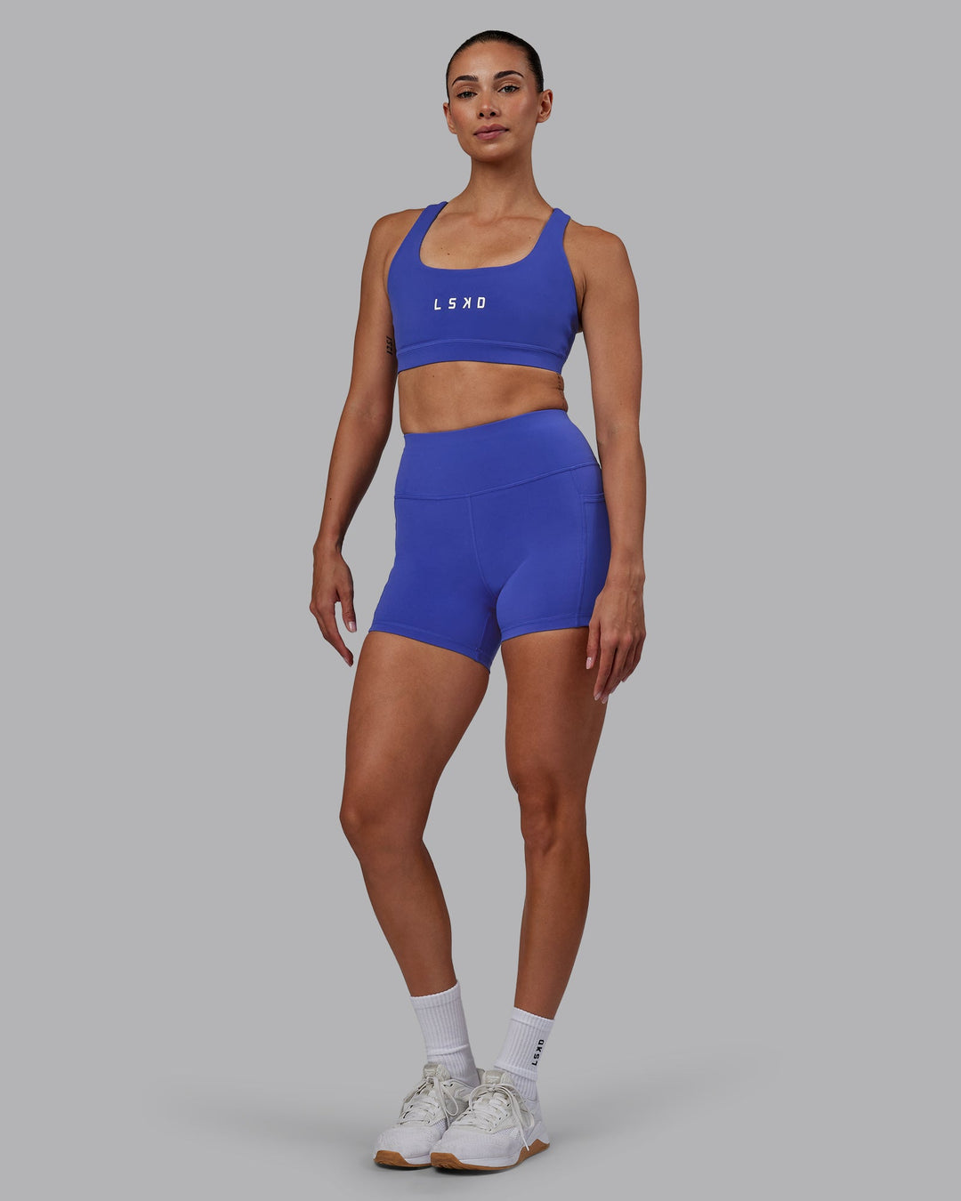 Woman wearing Rep Sports Bra - Power Cobalt-White