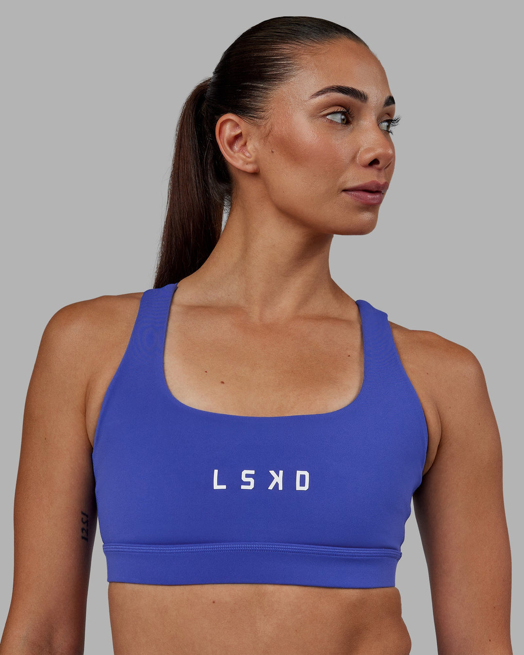 Woman wearing Rep Sports Bra - Power Cobalt-White