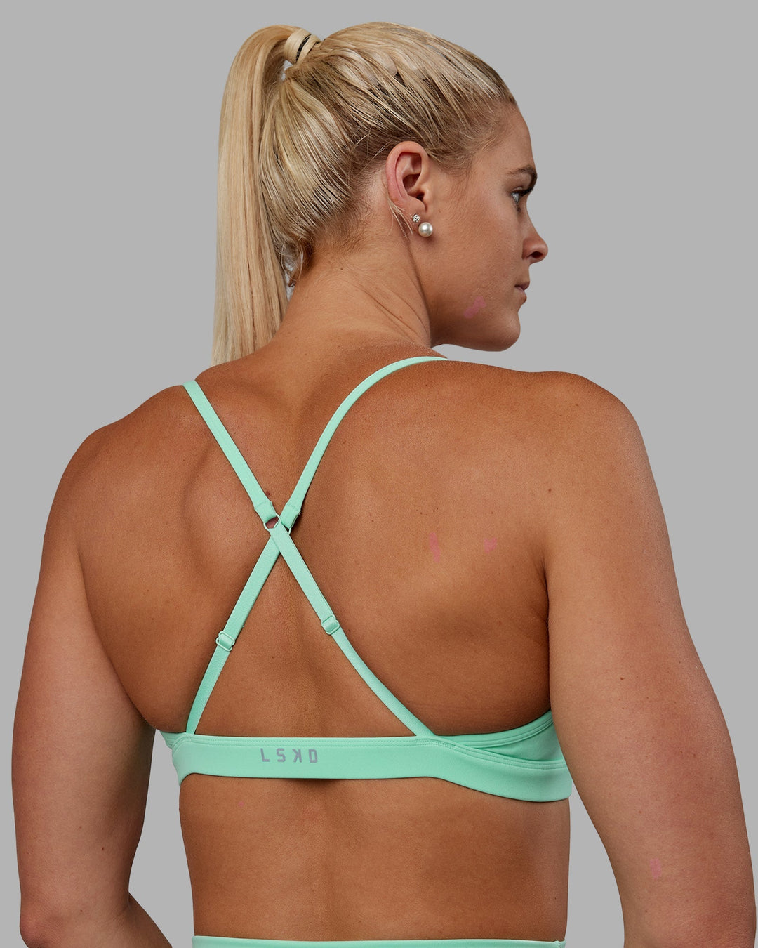 Woman wearing Resilient Sports Bra - Ice Green