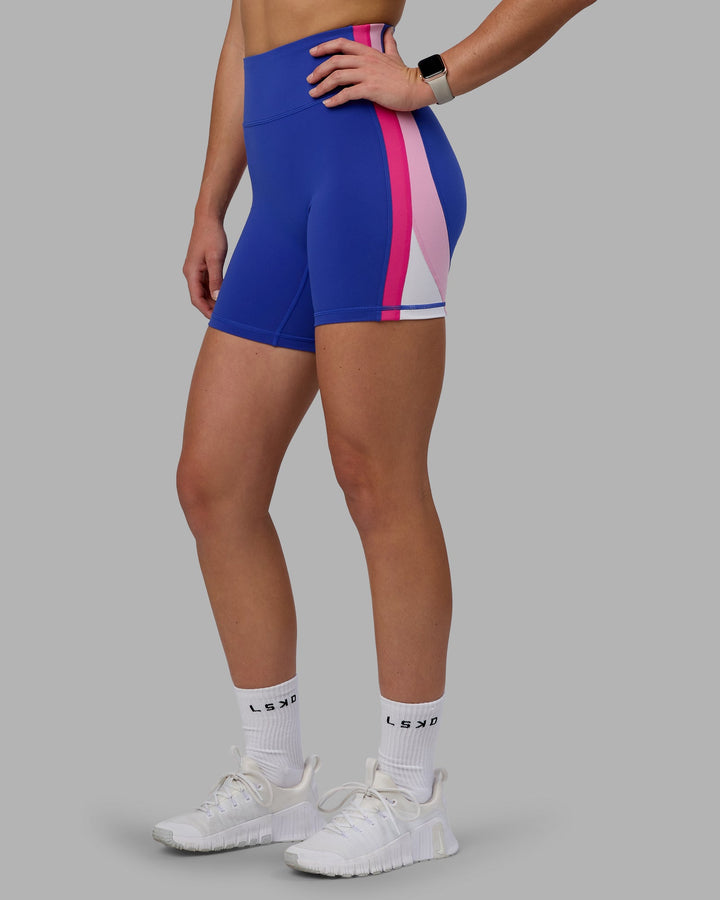 Woman wearing Revitalise Mid Short Tights - Power Cobalt-Fuchsia Pink
