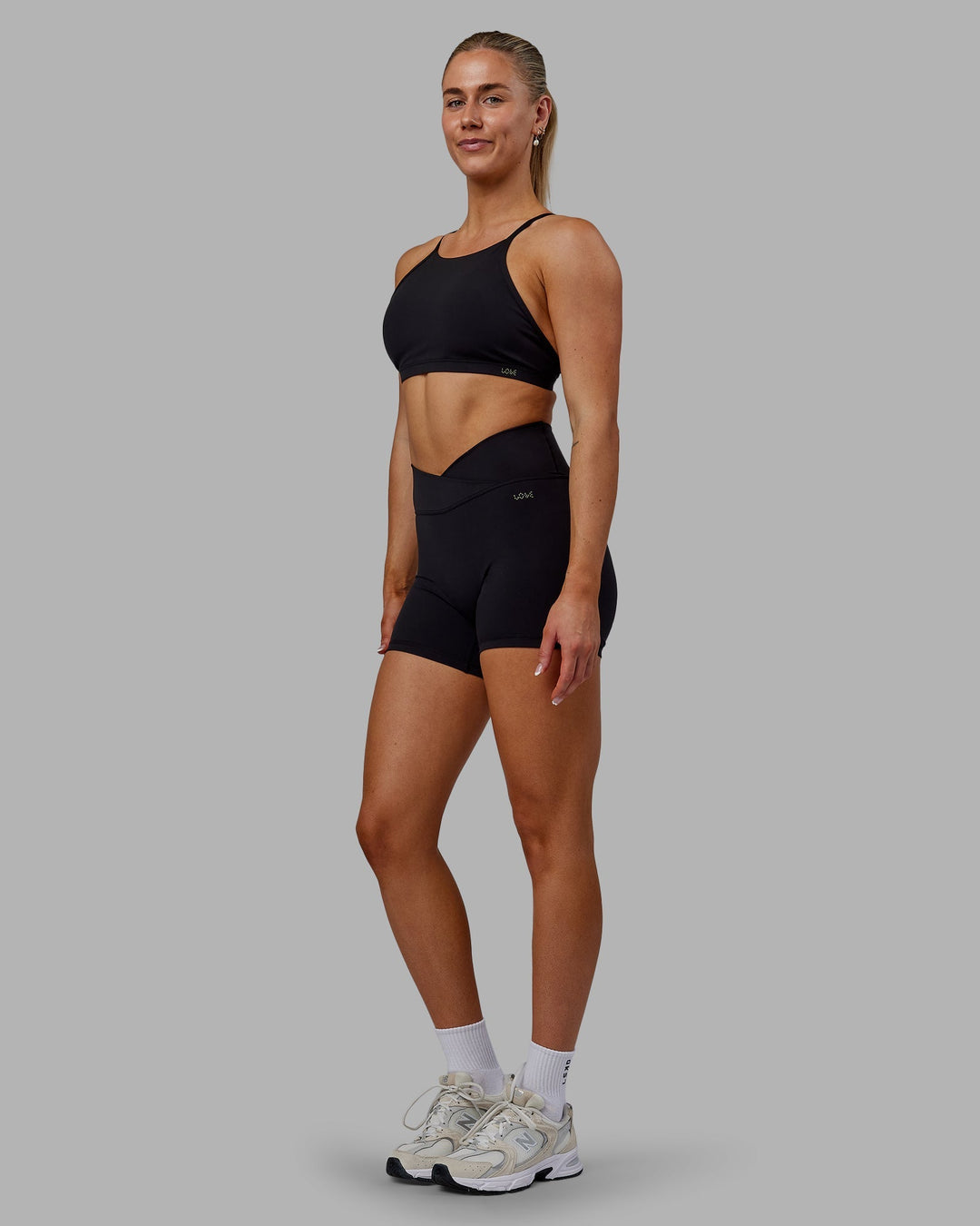 Woman wearing Sara Ares High Neck Sports Bra - Black