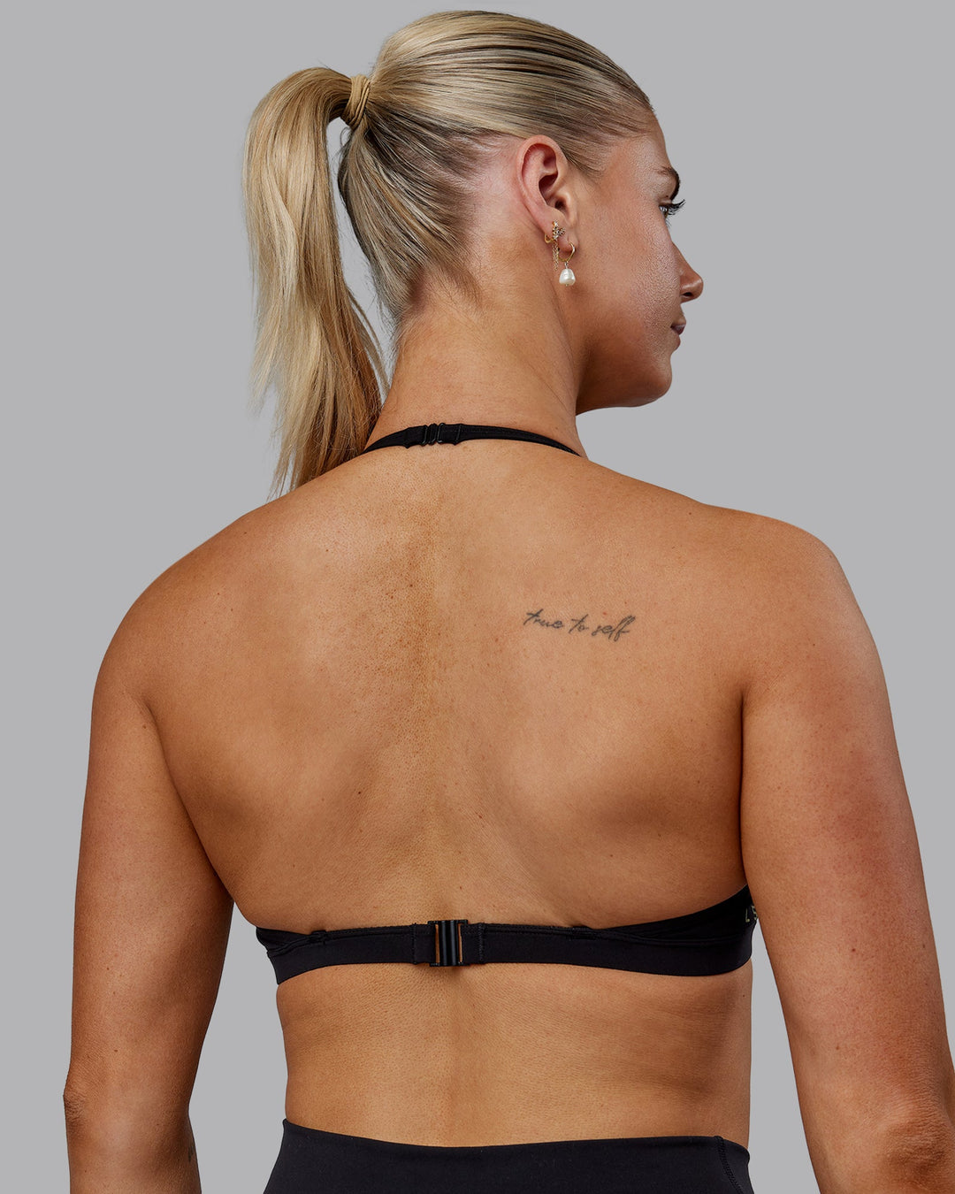 Woman wearing Sara Ares High Neck Sports Bra - Black