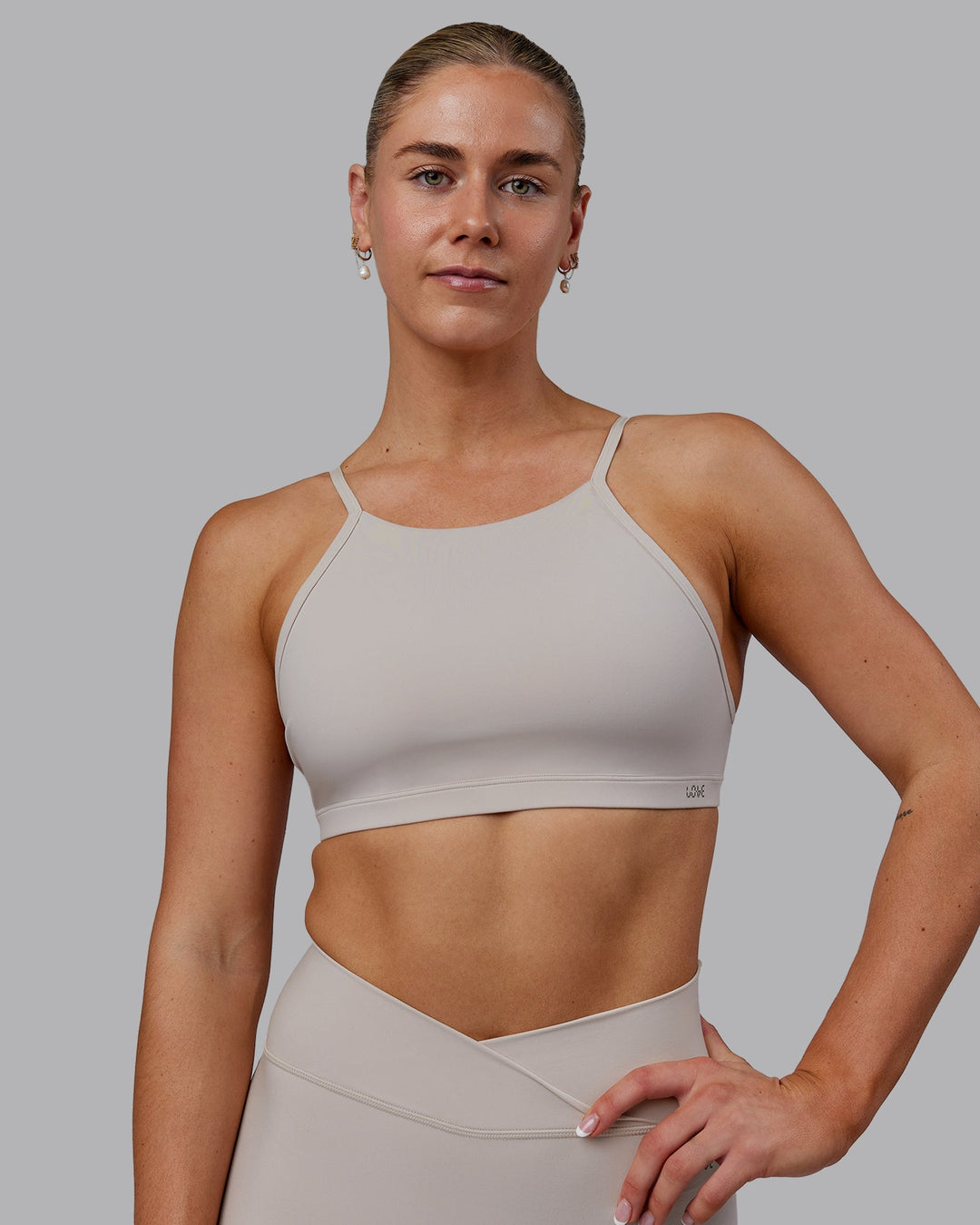 Woman wearing Sara Ares High Neck Sports Bra - Shale Beige