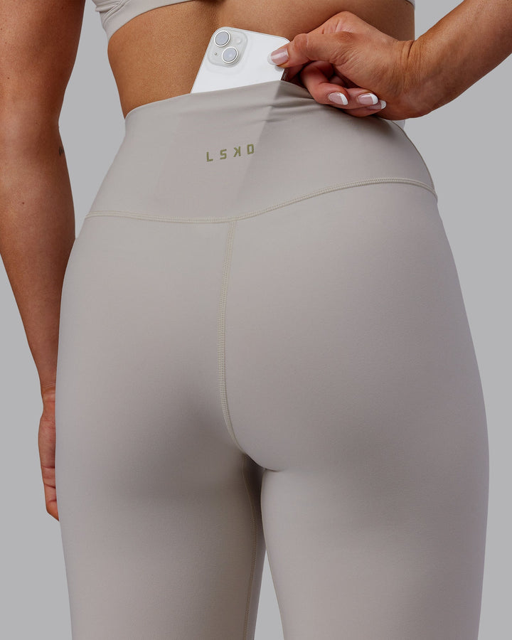 Woman wearing Sara Strike Cross Over Waist Full Length Leggings - Shale Beige
