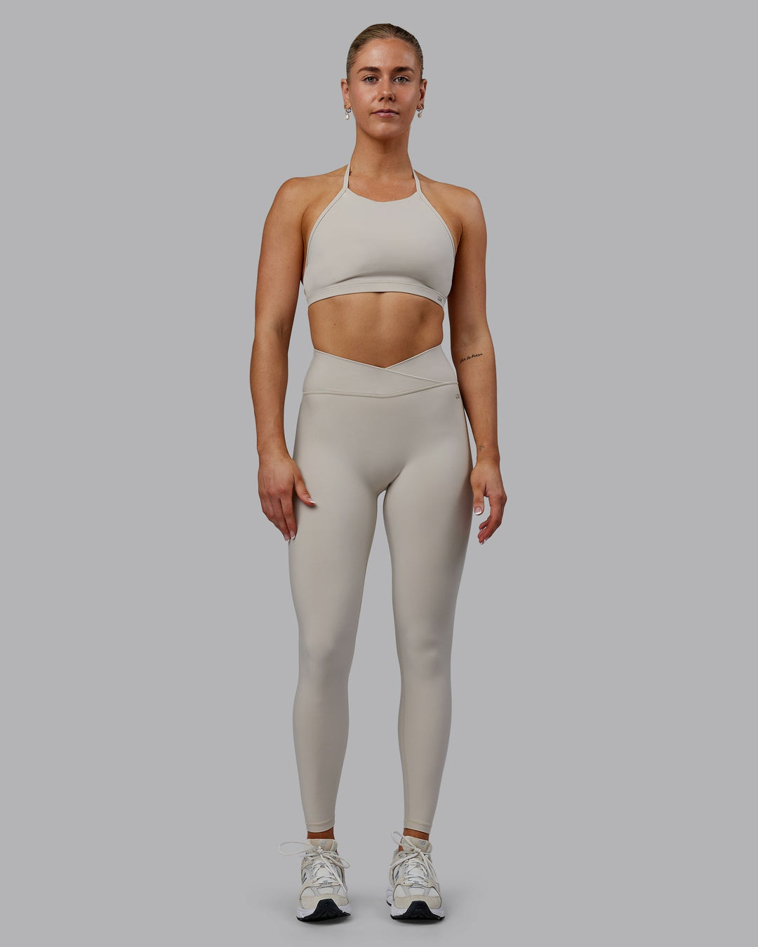 Woman wearing Sara Strike Cross Over Waist Full Length Leggings - Shale Beige