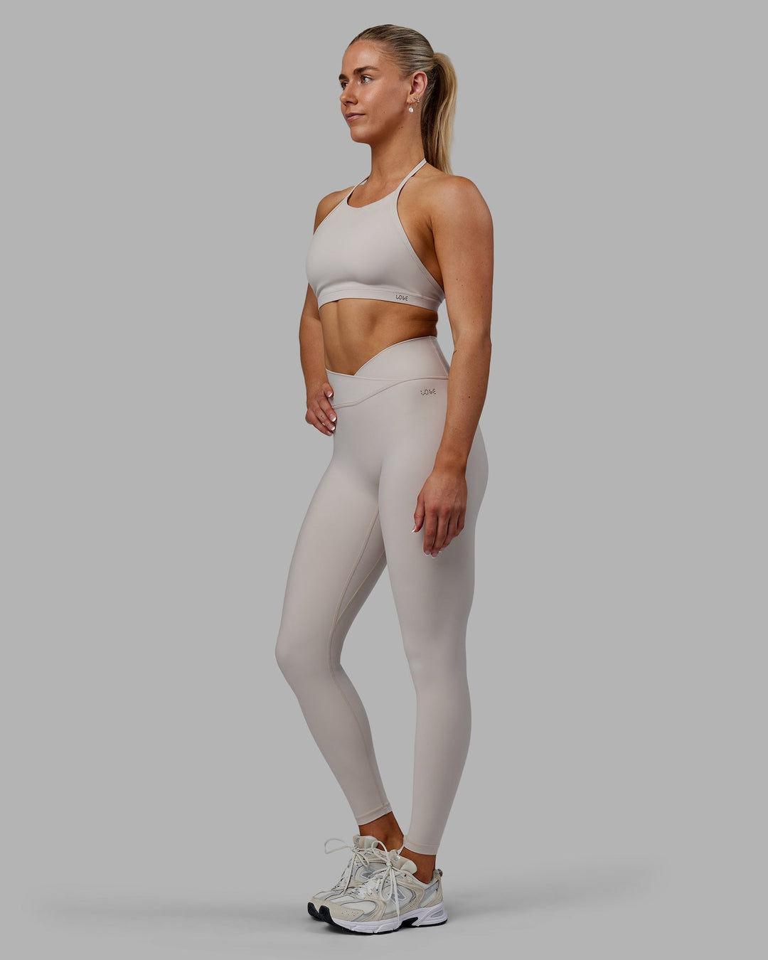 Woman wearing Sara Strike Cross Over Waist Full Length Leggings - Shale Beige