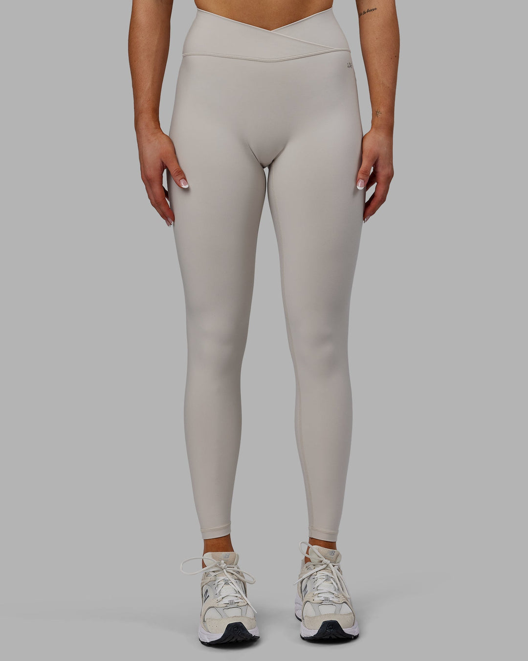 Woman wearing Sara Strike Cross Over Waist Full Length Leggings - Shale Beige