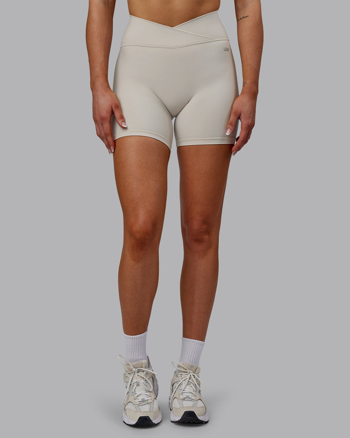 Woman wearing Sara Strike Cross Over Waist Mid-Length Shorts - Shale Beige
