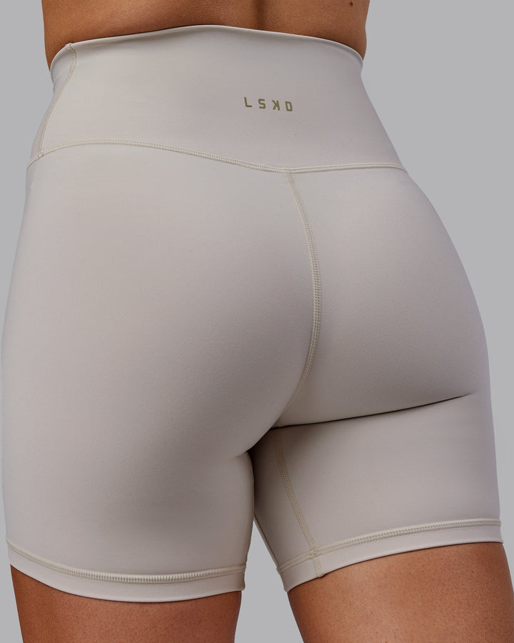 Woman wearing Sara Strike Cross Over Waist Mid-Length Shorts - Shale Beige
