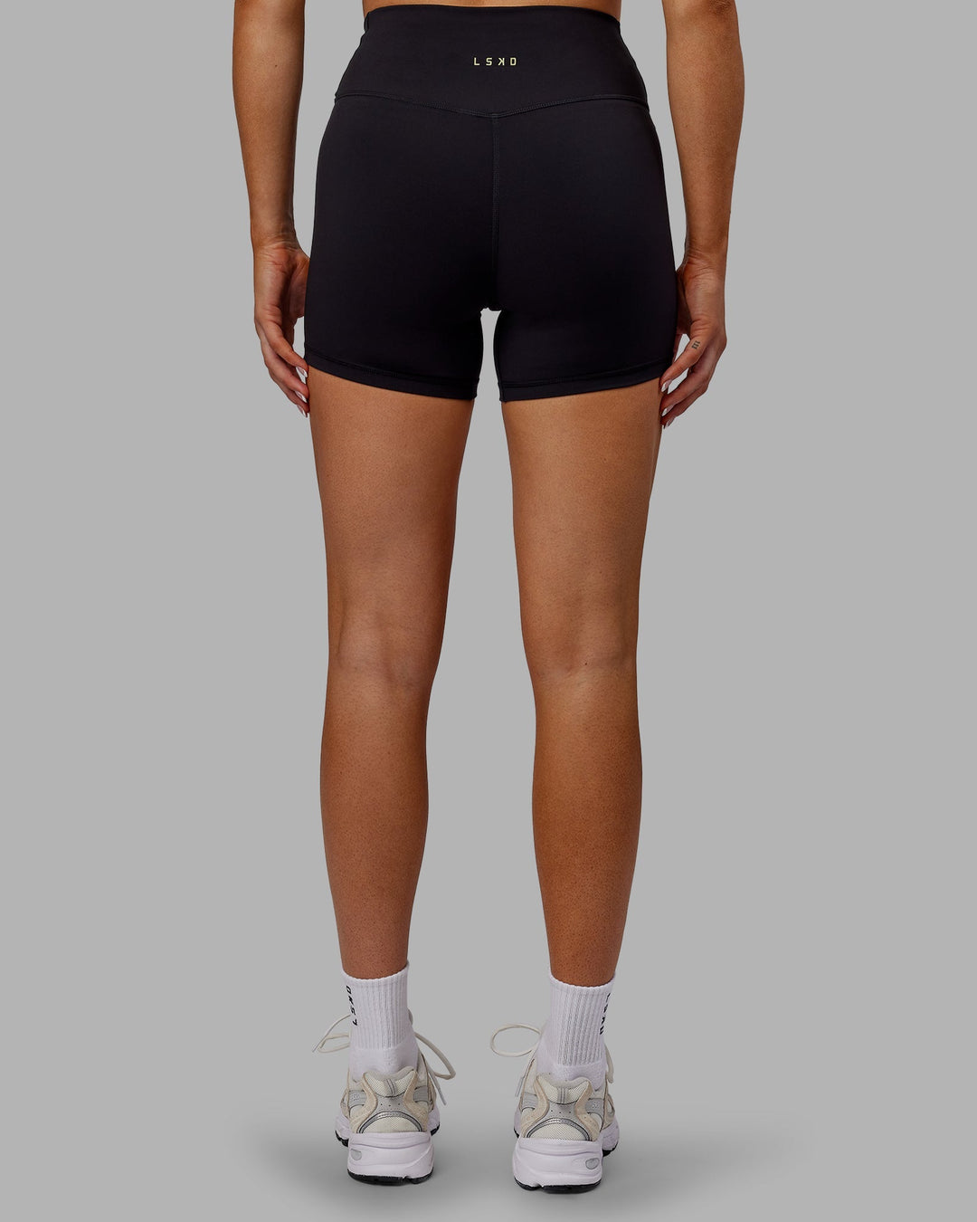 Woman wearing Sara Strike Cross Over Waist X-Length Shorts - Black