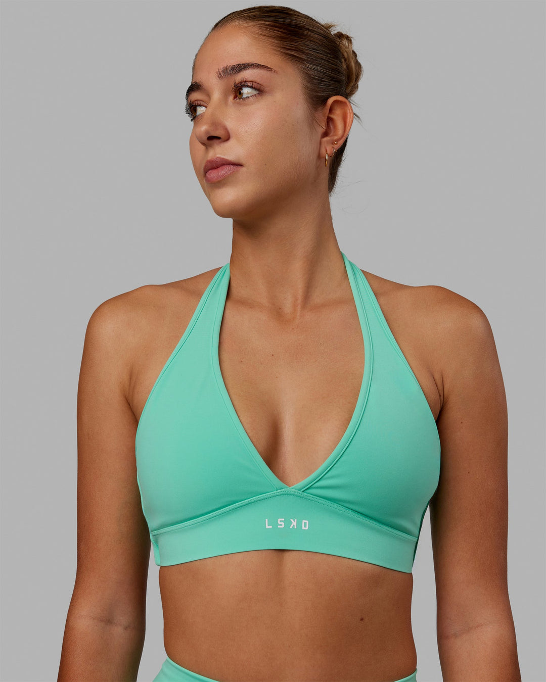 Woman wearing Stamina Halter Sports Bra - Cockatoo