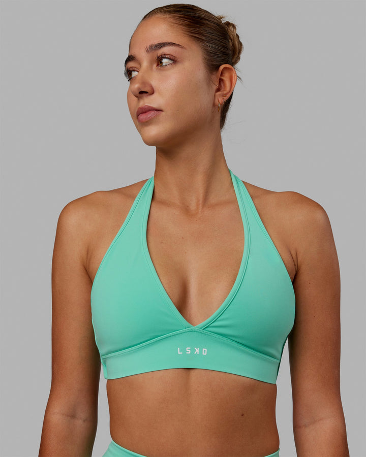 Woman wearing Stamina Halter Sports Bra - Cockatoo
