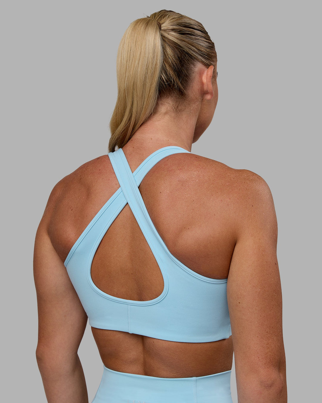 Woman wearing Stamina Sports Bra - Glacial Blue