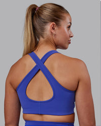 Woman wearing Stamina Sports Bra - Power Cobalt | Set:true | Angle:back | Model:Hannah | Size:S