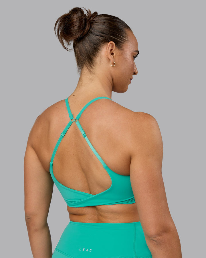 Woman wearing Twist Sports Bra - Atlantis
