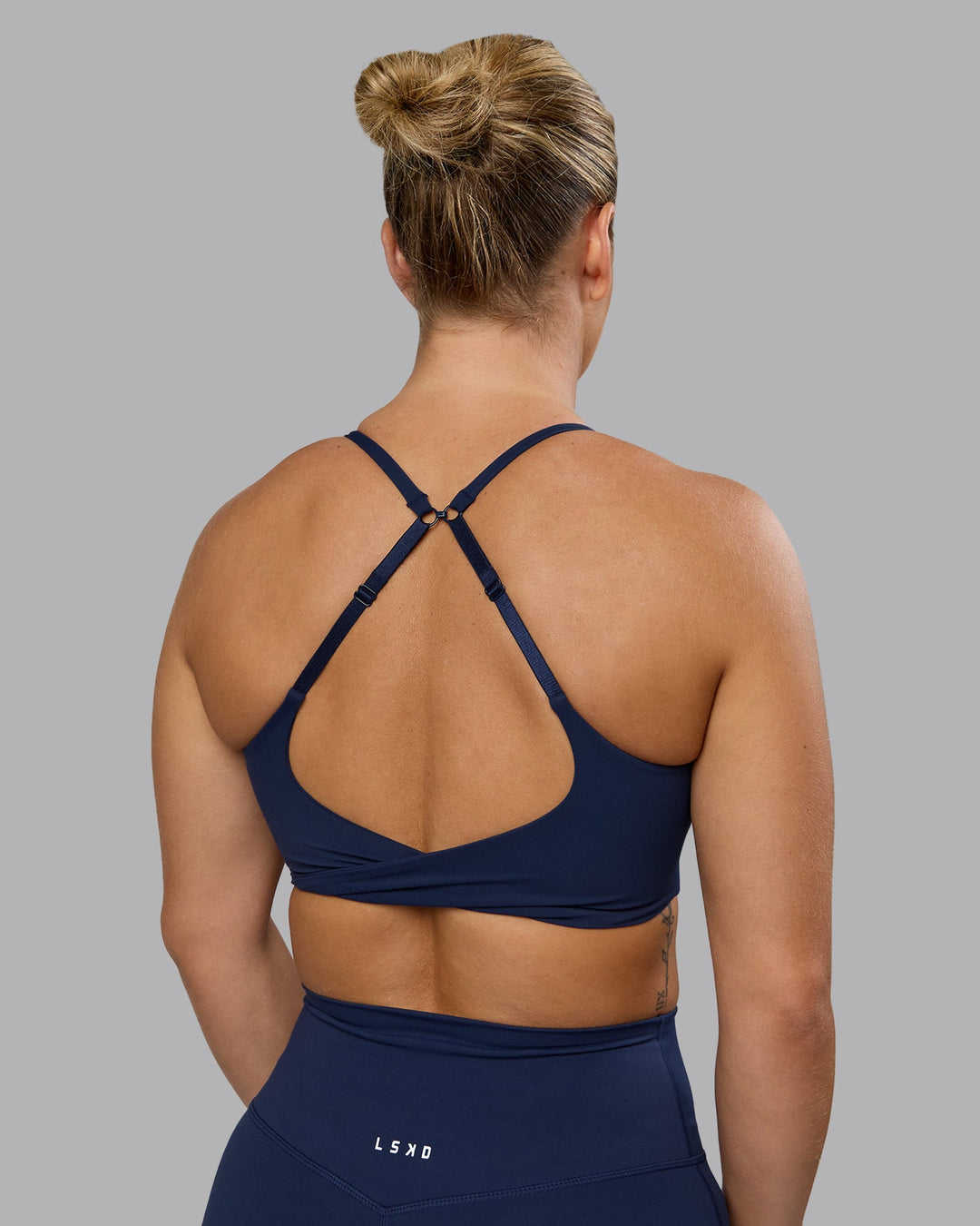 Woman wearing Twist Sports Bra - Future Navy