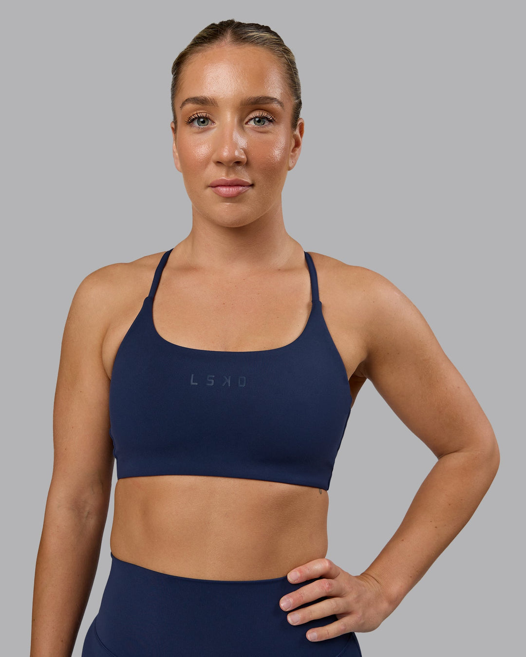 Woman wearing Twist Sports Bra - Future Navy