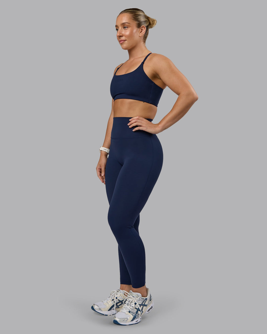 Woman wearing Twist Sports Bra - Future Navy