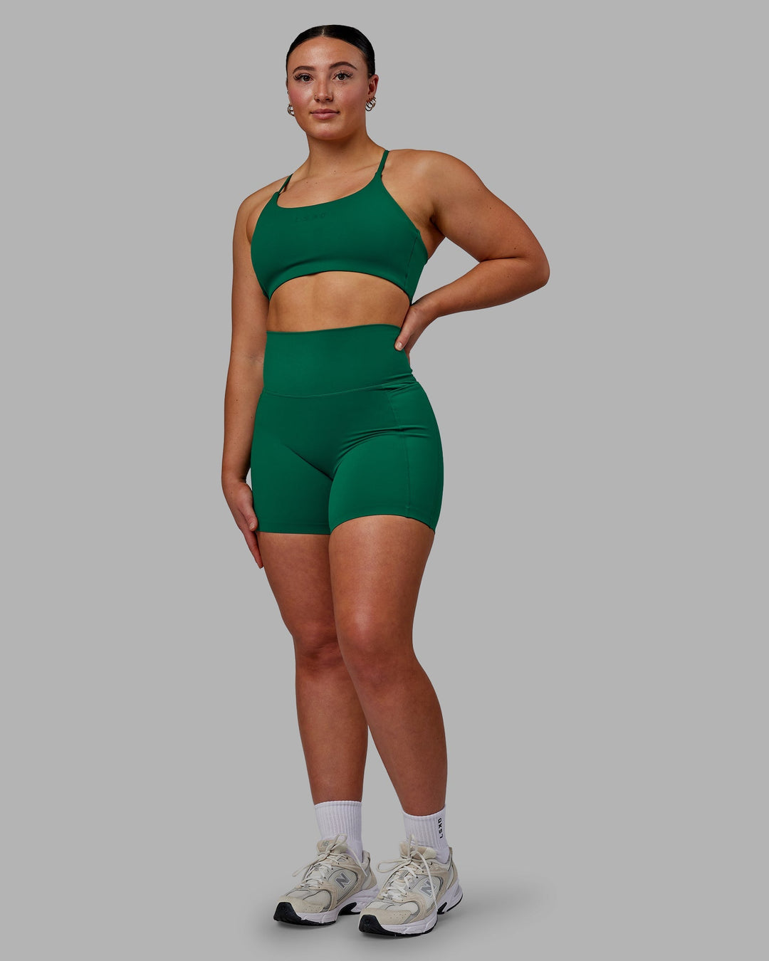 Woman wearing Twist Sports Bra - Malachite