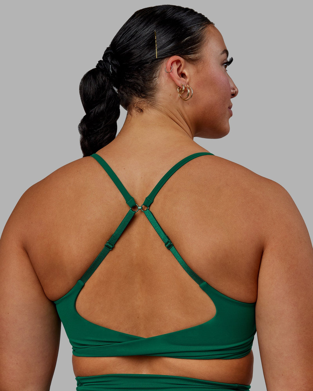 Woman wearing Twist Sports Bra - Malachite