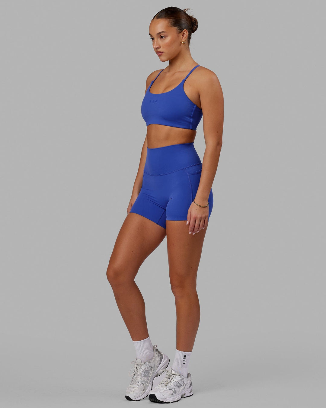 Woman wearing Twist Sports Bra - Power Cobalt