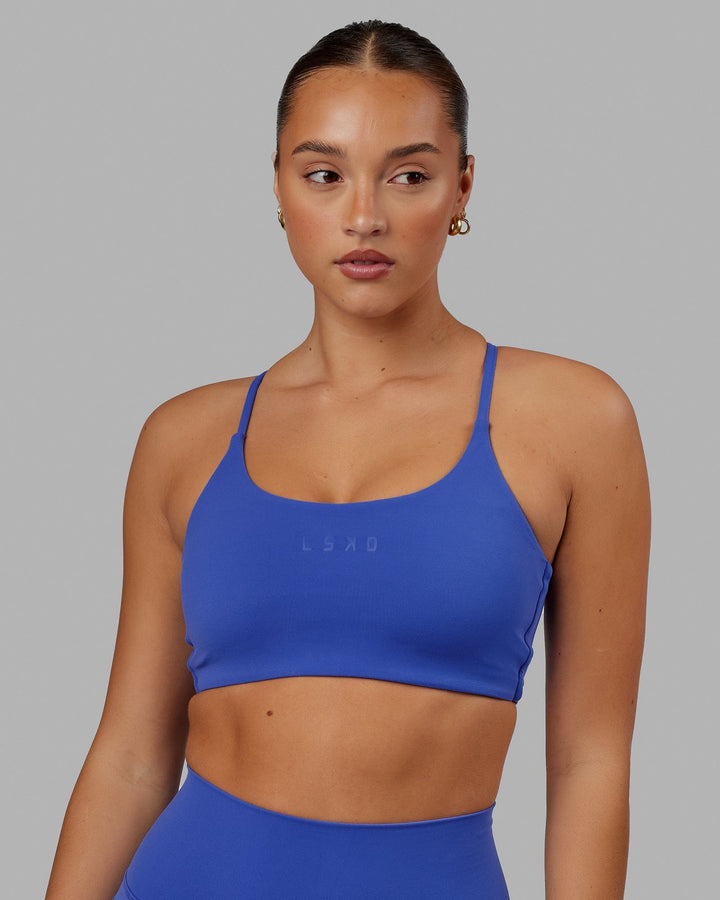 Woman wearing Twist Sports Bra - Power Cobalt
