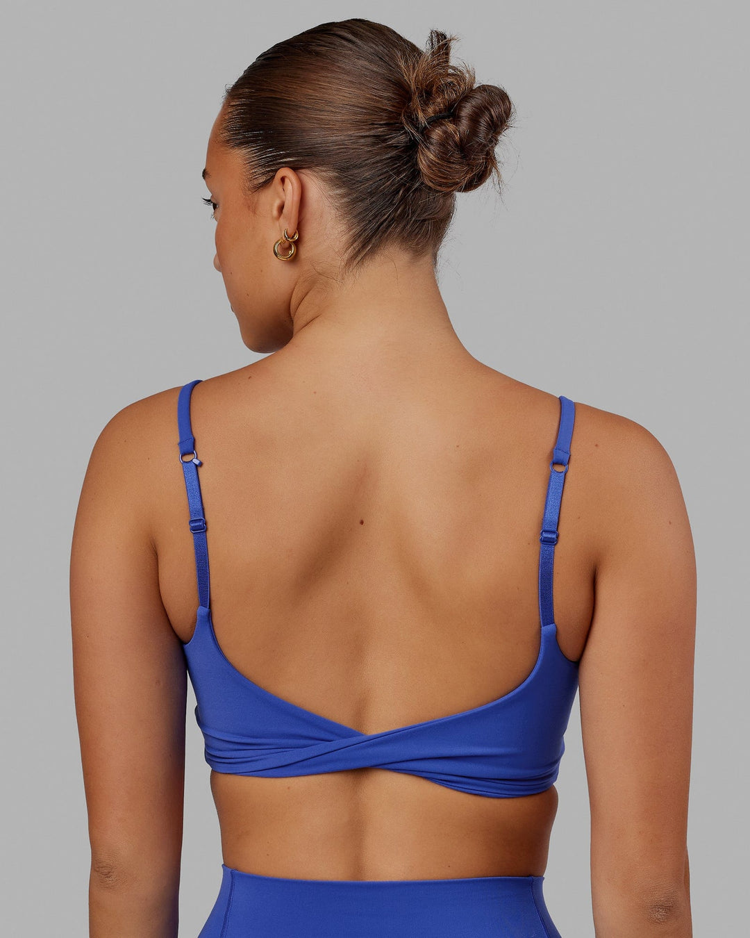 Woman wearing Twist Sports Bra - Power Cobalt