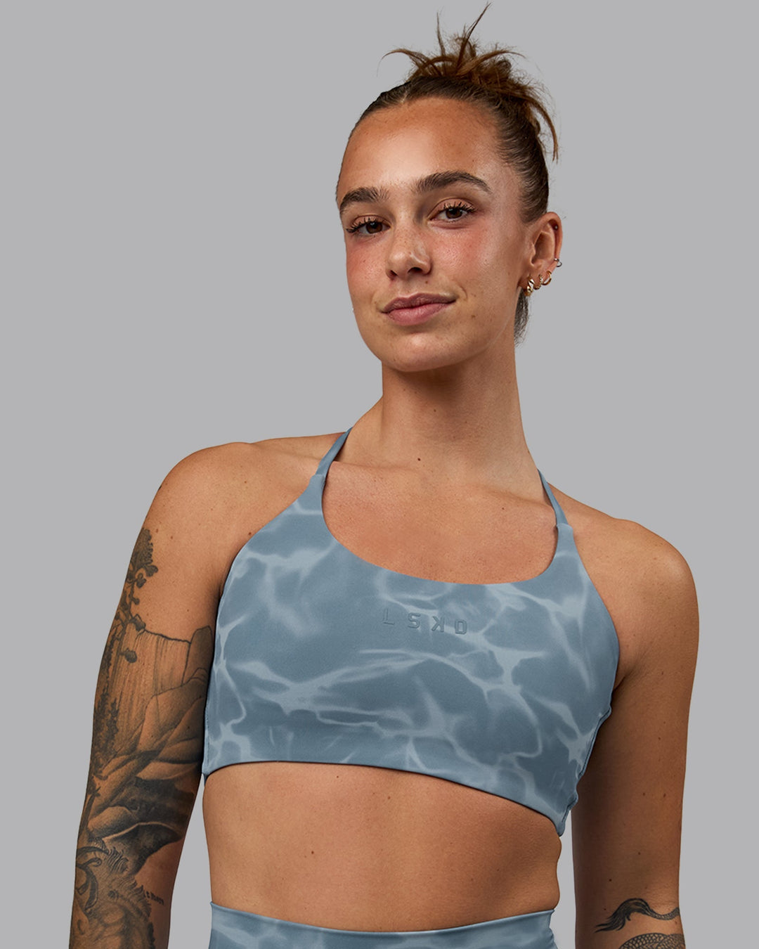 Woman wearing Twist Sports Bra - Tranquil-Elemental Blue