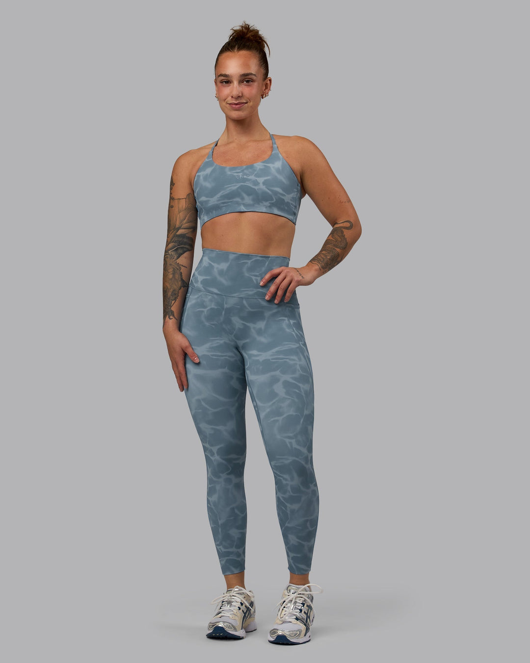 Woman wearing Twist Sports Bra - Tranquil-Elemental Blue