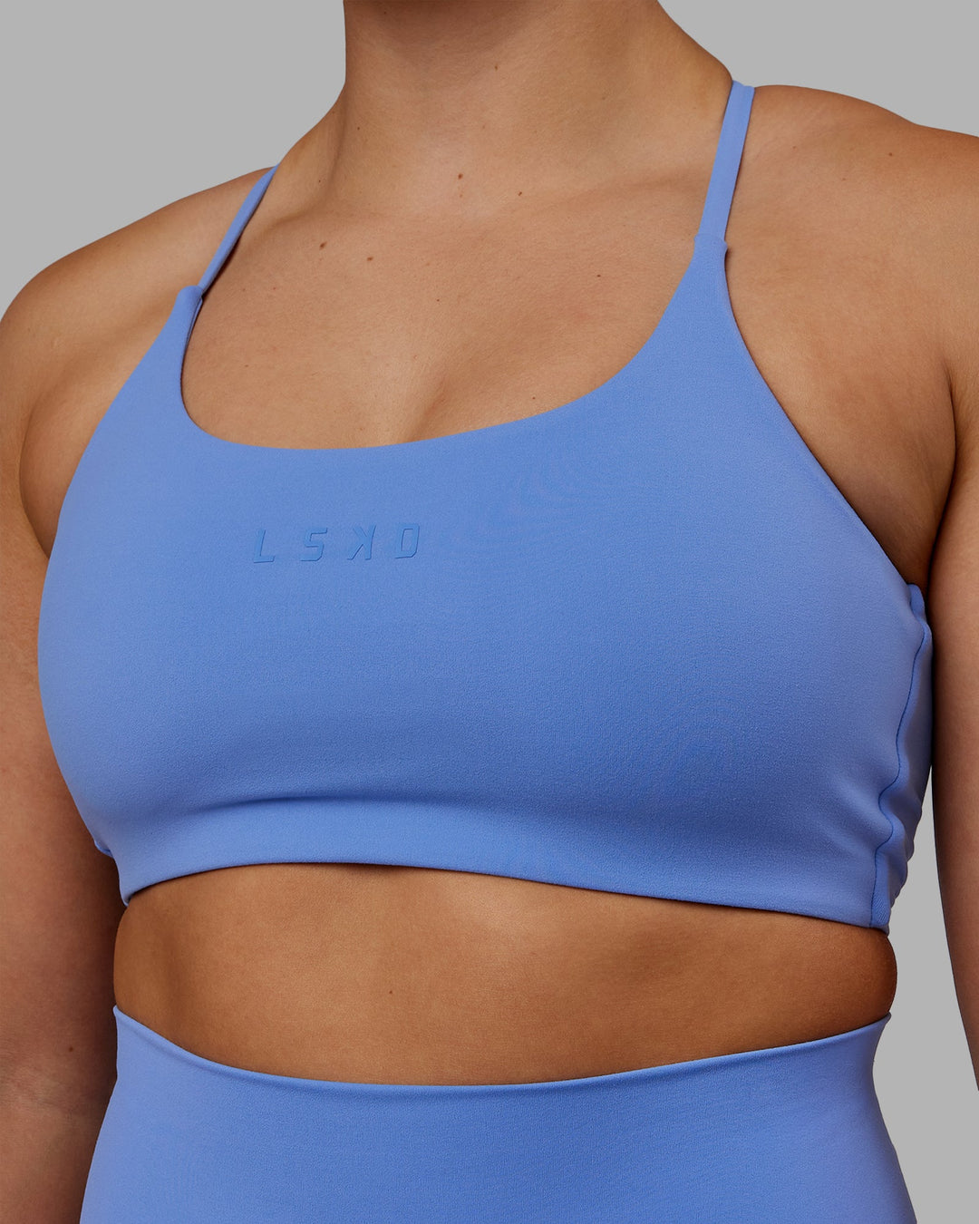 Woman wearing Twist Sports Bra - Ultramarine