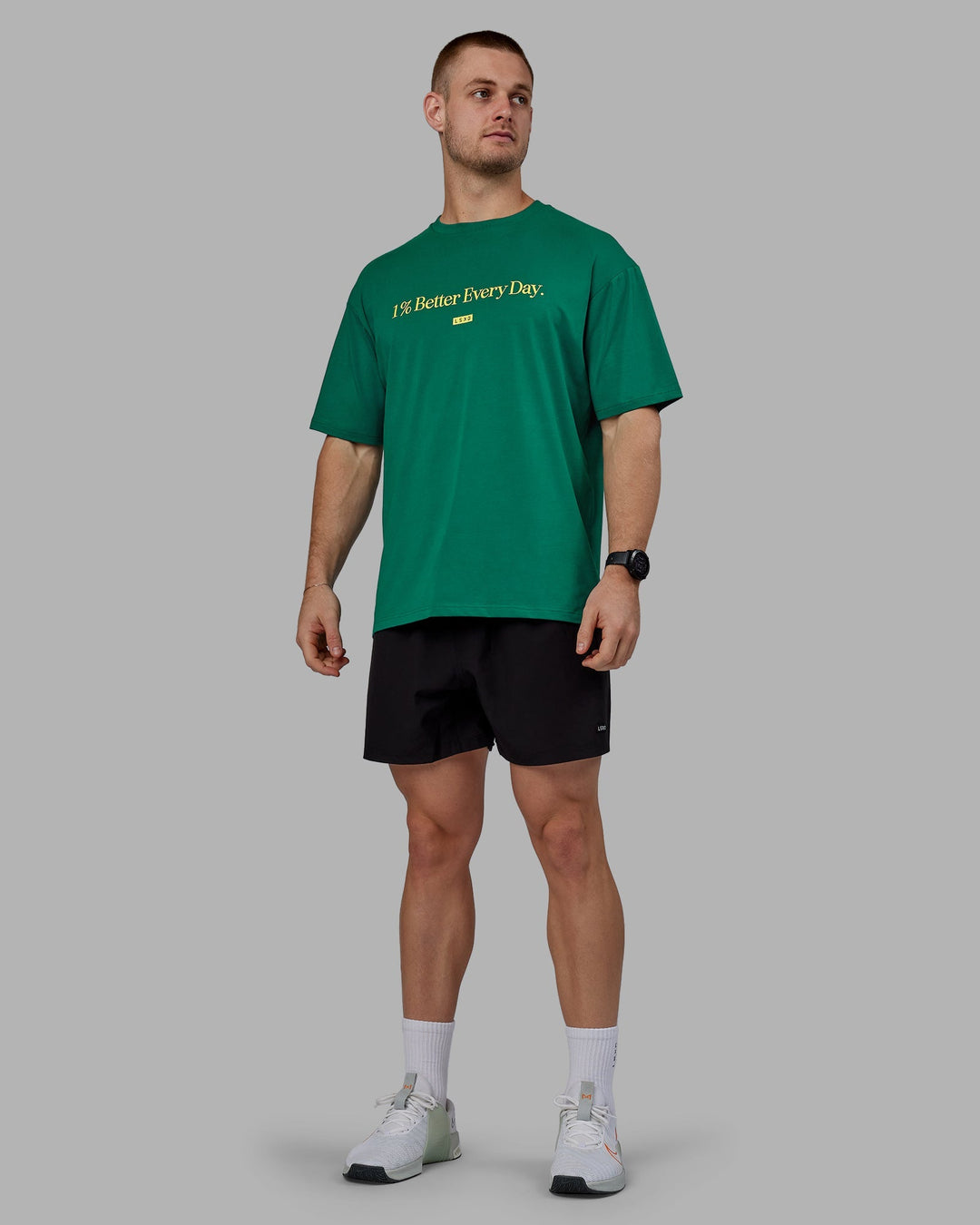 Man wearing Unisex 1% Better FLXCotton Tee Oversize - Green-Gold