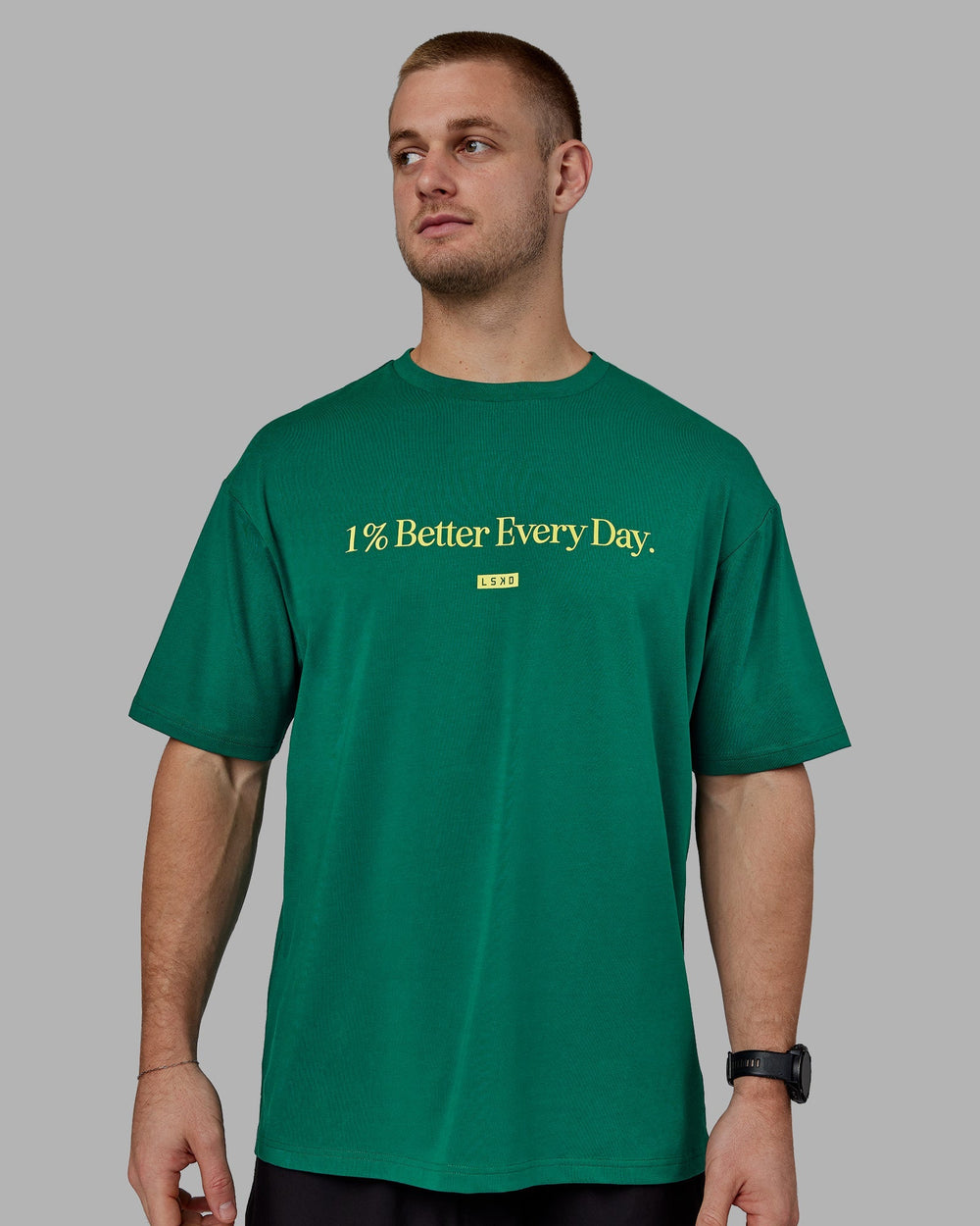 Man wearing Unisex 1% Better FLXCotton Tee Oversize - Green-Gold