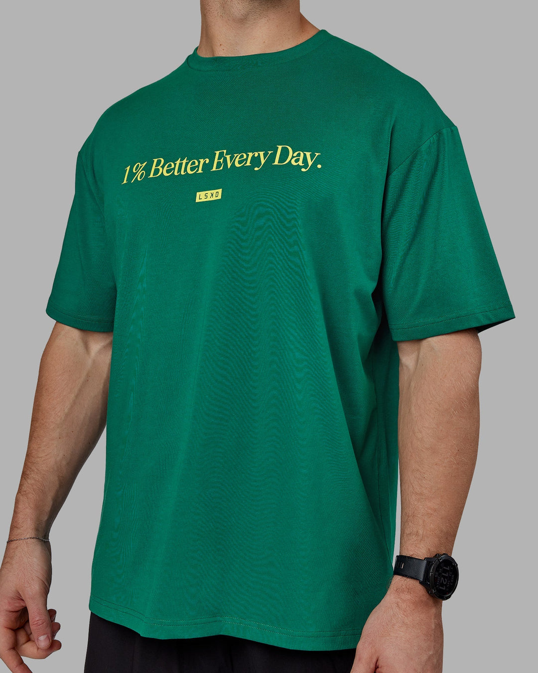 Man wearing Unisex 1% Better FLXCotton Tee Oversize - Green-Gold