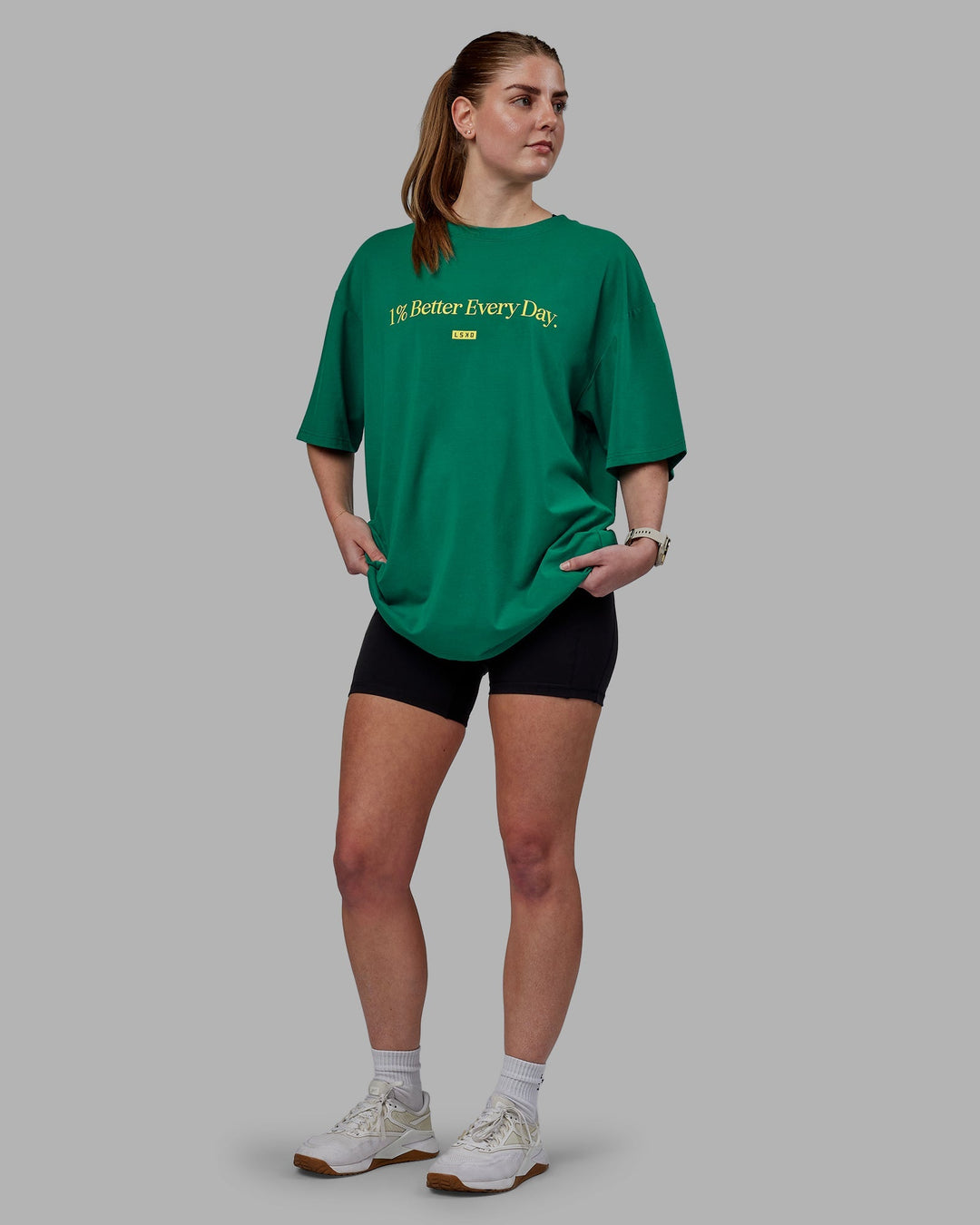 Woman wearing Unisex 1% Better FLXCotton Tee Oversize - Green-Gold