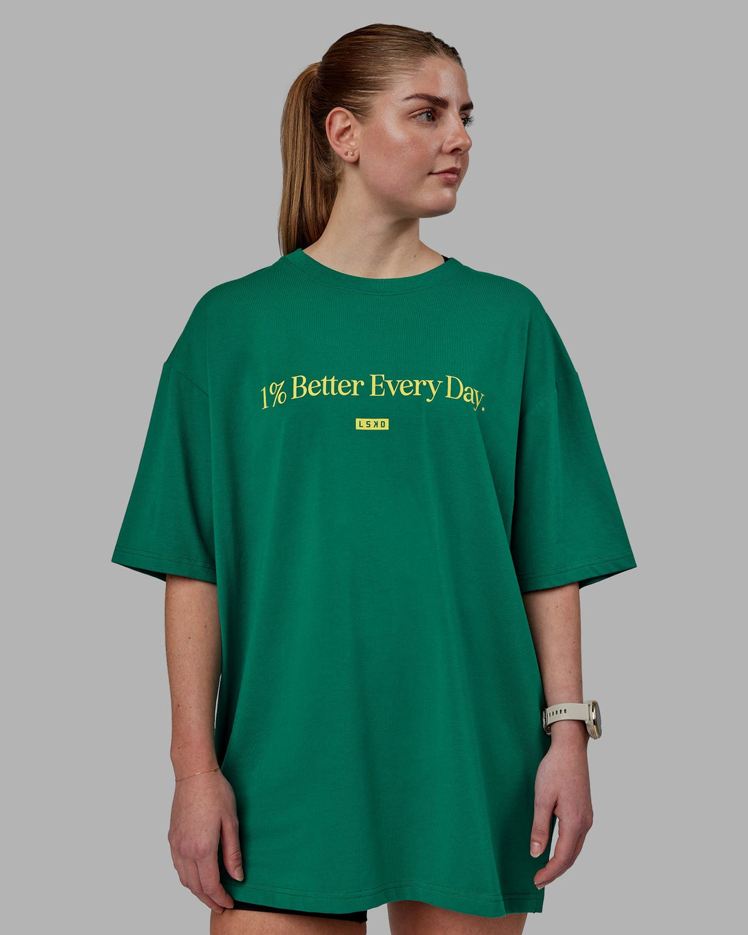 Woman wearing Unisex 1% Better FLXCotton Tee Oversize - Green-Gold