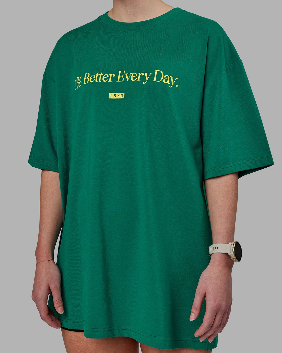 Woman wearing Unisex 1% Better FLXCotton Tee Oversize - Green-Gold