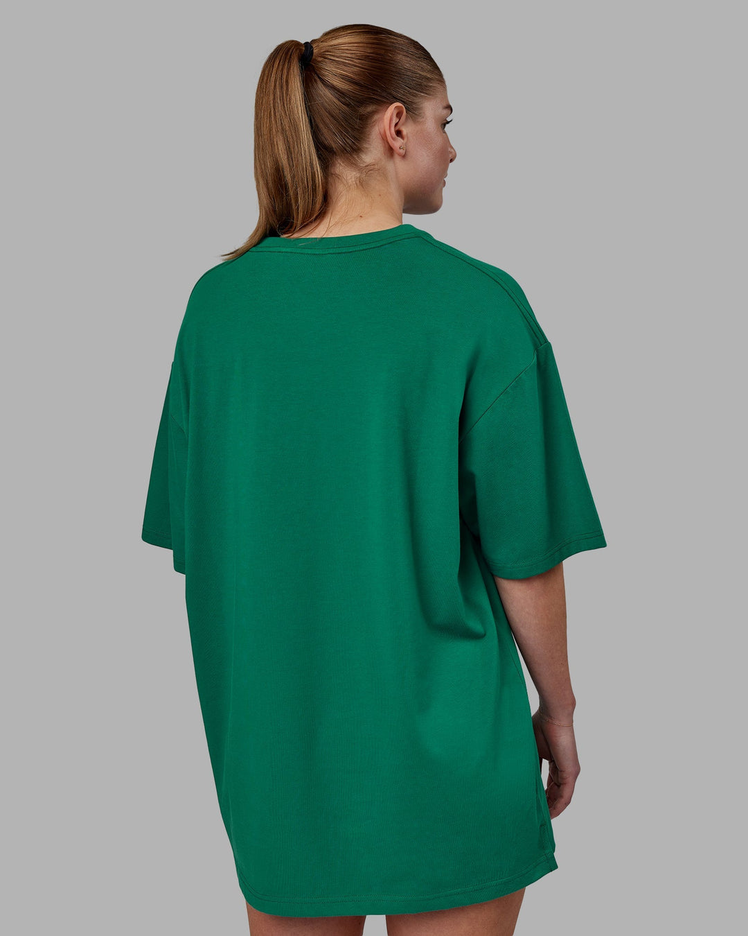 Woman wearing Unisex 1% Better FLXCotton Tee Oversize - Green-Gold