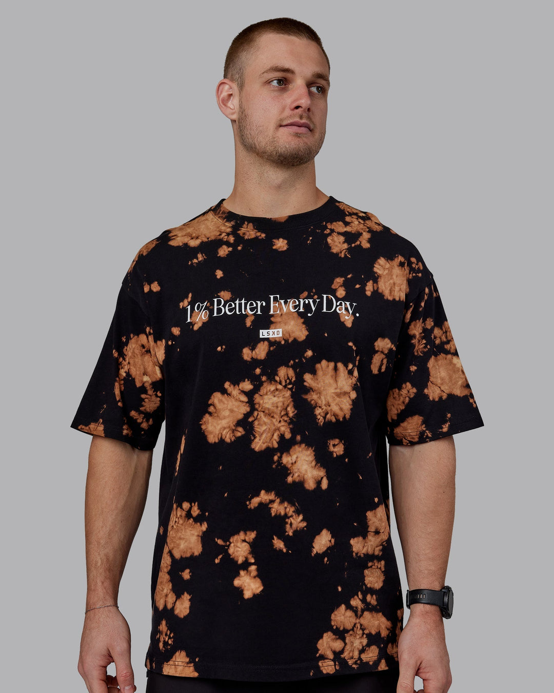 Man wearing Unisex 1% Better Heavyweight Tee Oversize - Black-Bleach Tie Dye