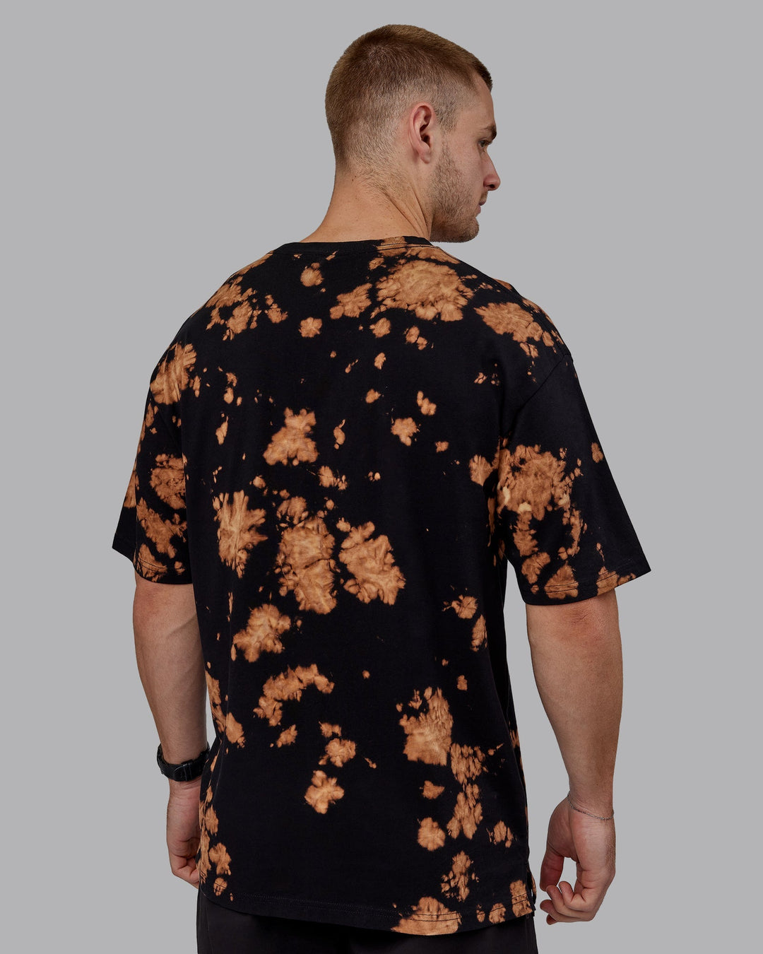 Man wearing Unisex 1% Better Heavyweight Tee Oversize - Black-Bleach Tie Dye