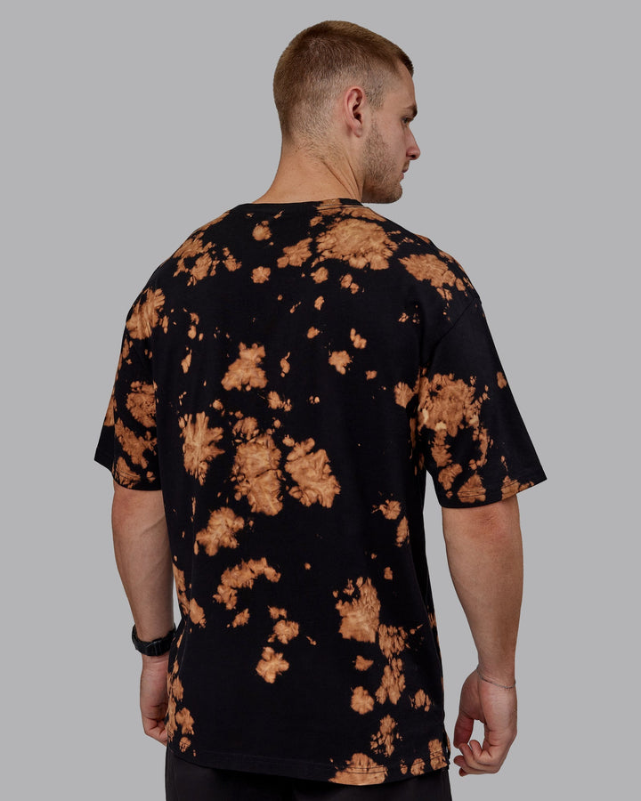 Man wearing Unisex 1% Better Heavyweight Tee Oversize - Black-Bleach Tie Dye
