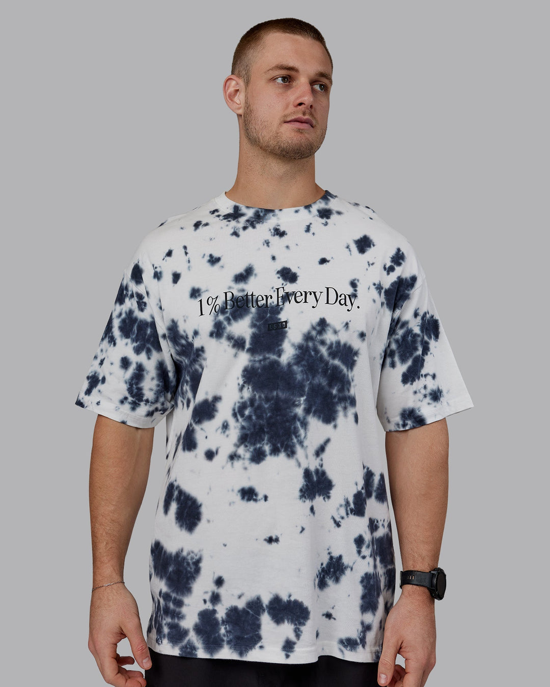 Man wearing Unisex 1% Better Heavyweight Oversize Tee - White-Black Tie Dye