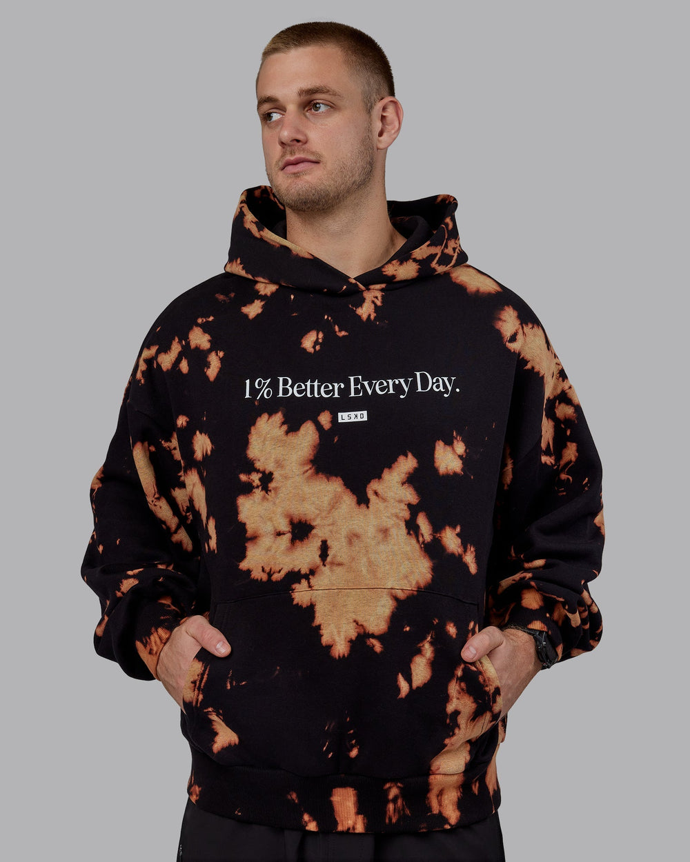 Man wearing Unisex 1% Better Hoodie Oversize - Black-Bleach-Tie Dye