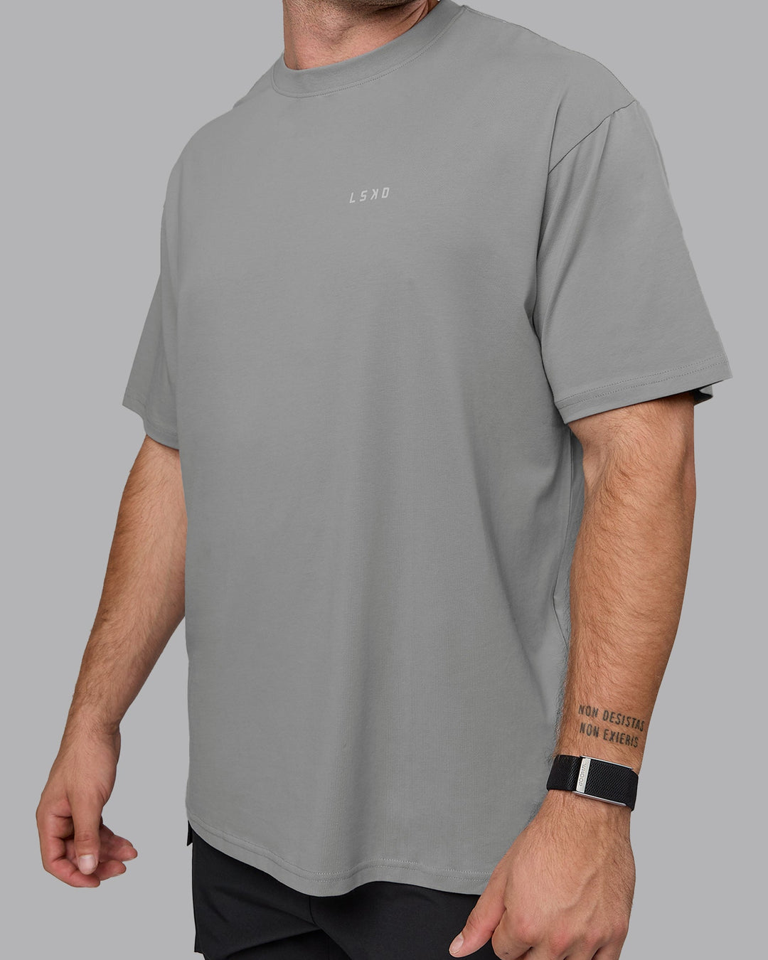 Man wearing Unisex 1% Better Value Series FLXCotton Tee Oversize - Circular Grey-White