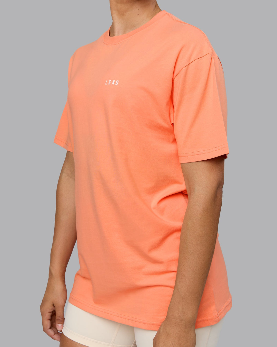 Woman wearing Unisex 1% Better Value Series FLXCotton Tee Oversize - Mellow Peach-White