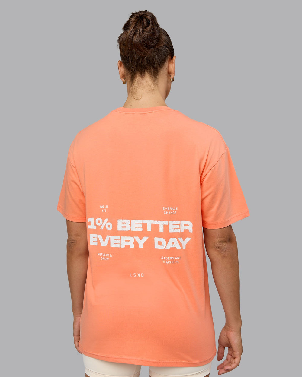 Woman wearing Unisex 1% Better Value Series FLXCotton Tee Oversize - Mellow Peach-White