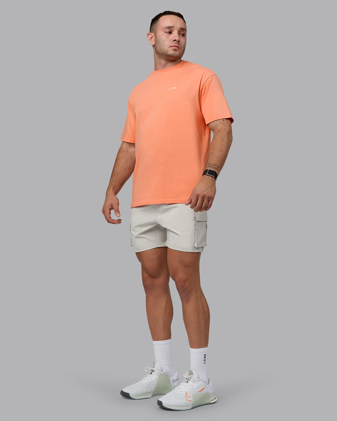 Man wearing Unisex 1% Better Value Series FLXCotton Tee Oversize - Mellow Peach-White